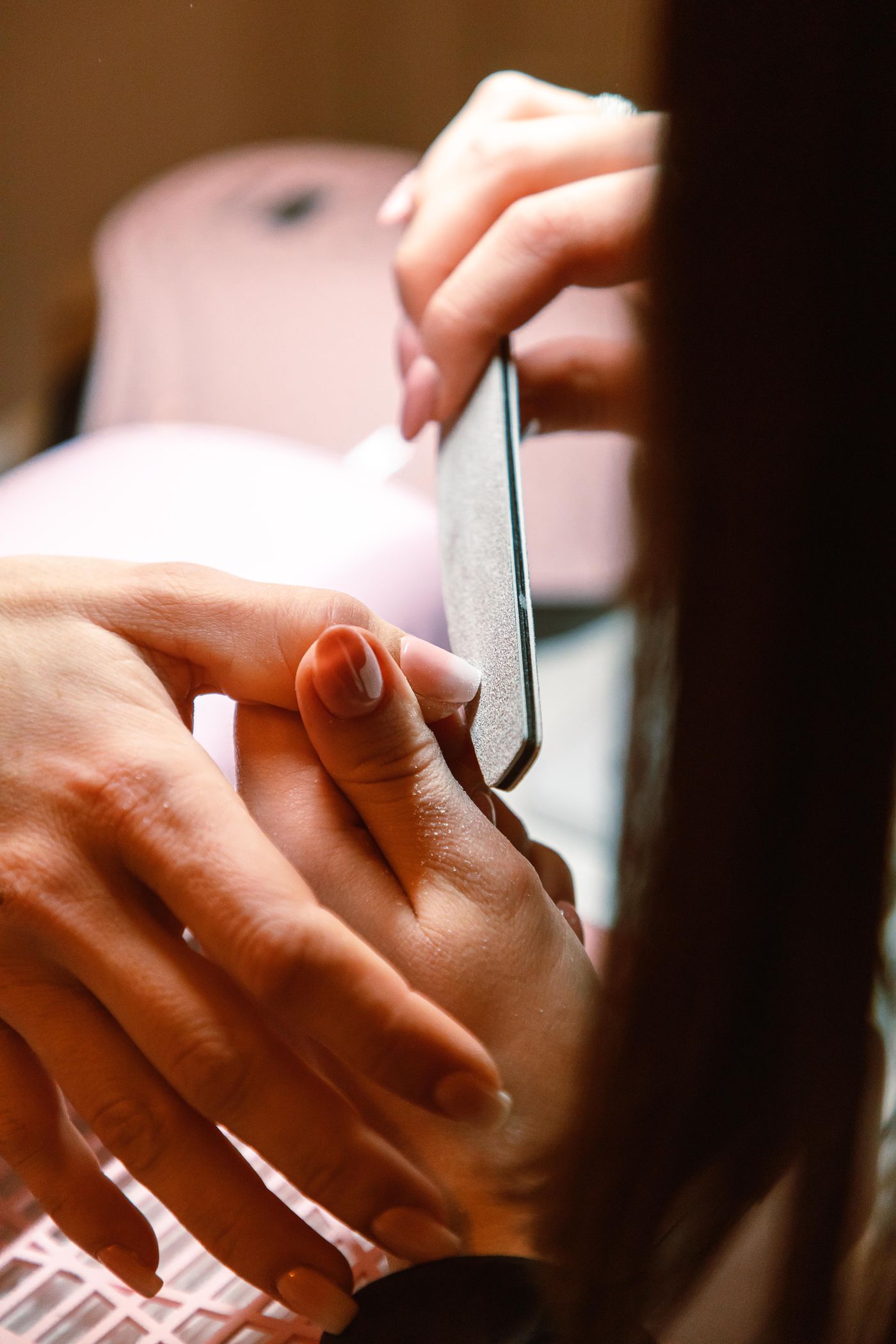 Nail shaping during a manicure appointment